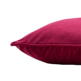 Close-up corner view of the Hortus Animal Velvet Cushion in fuchsia, showing plush velvet pile and piped edge seam against a plain white background.