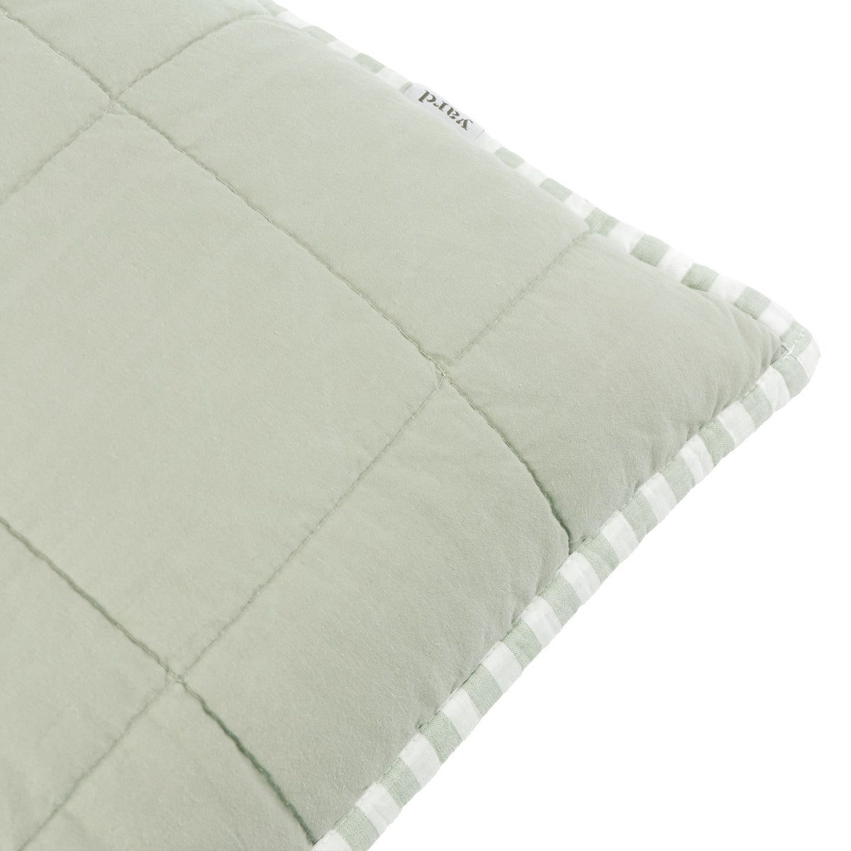 Close-up of the Hebden Percale Cotton Cushion in Eucalyptus/Bay Green, showing quilted sage cotton front and striped green-and-white edge trim on a white background.
