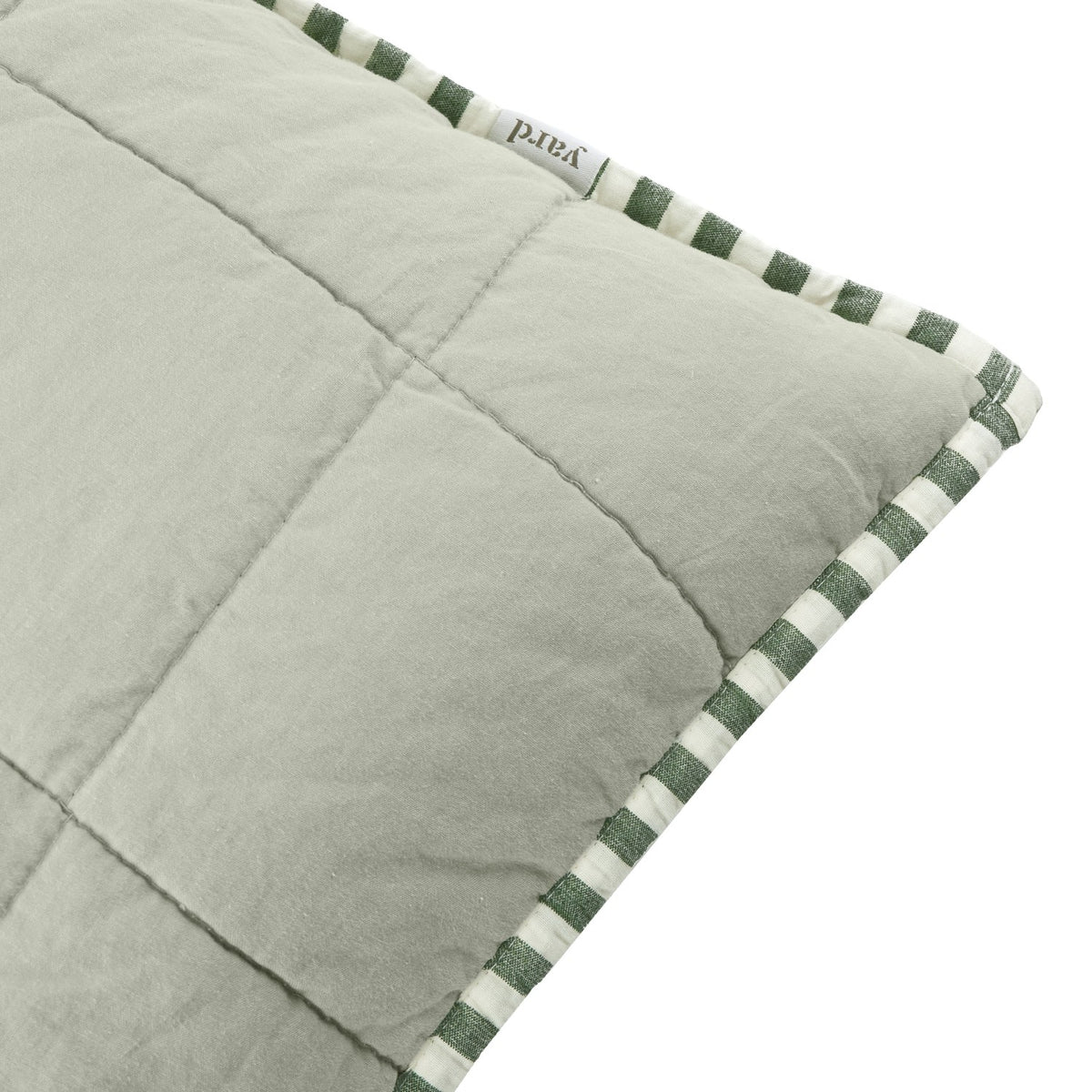 Close-up of the Hebden Percale Cotton Cushion in sage green, showing quilted grid-stitched fabric edged with green and cream striped piping.