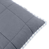 Close-up of the Hebden Percale Cotton Cushion showing the box-quilted mineral blue cotton face and reverse blue-and-white striped edge with gingham border, on a white background.
