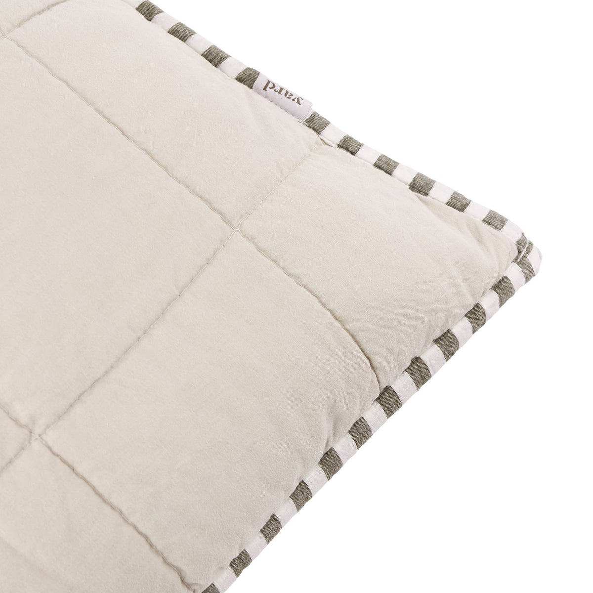 Close-up of the Hebden Percale Cotton Cushion in stone, showing the quilted grid pattern and striped mole grey Oxford-style border on a white background.