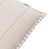 Close-up of the Hebden Percale Cotton Cushion in Natural/Stone, showing the quilted stone-beige front with grid stitching and striped Oxford border edge, on a white background.