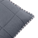 Close-up of the Hebden Percale Cotton Cushion in denim blue, showing box-stitched quilting and a striped navy and cream edge trim with fabric brand tag.