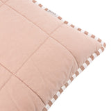Close-up corner detail of the Hebden Percale Cotton Cushion in pecan pink, showing quilted grid stitching on cotton with a pecan-and-white striped edge trim, on a plain white background.