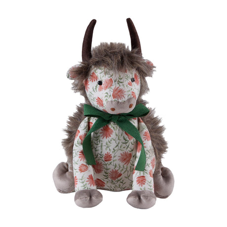 Hugo Polyester Door Stop shaped as a highland cow, with shaggy mane, dark curved horns, grey muzzle and paws, a coral floral print body tied with a green ribbon bow, on a plain white background.