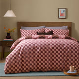 Huxley Reversible Check Duvet Cover Set in chocolate and blush on a bed with matching pillowcases, wooden headboard, and neutral bedroom setting.