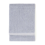 Hebden Plain Cotton Towel in denim blue, folded flat with a waffle-weave texture and plain woven border, shown on a white background.
