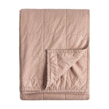Folded Hebden quilted cotton percale bedspread in warm pink (Cotta), showing a grid-stitched face and reverse corner fold, on a plain white background.