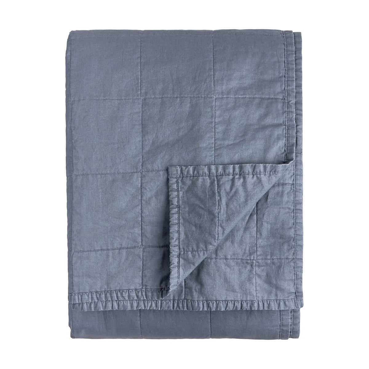 Hebden Percale Cotton Bedspread in denim blue, folded to show quilted grid stitching and matching reverse side, on a plain white background.