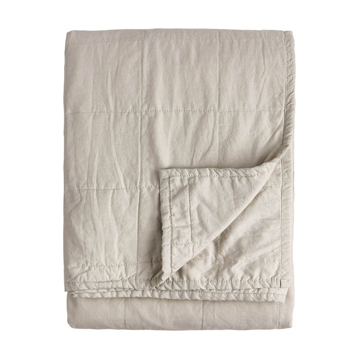 Hebden Percale Cotton Bedspread in stone, folded to show quilted grid stitching and a soft, garment-washed cotton texture on a plain white background.
