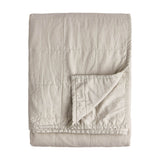 Hebden Percale Cotton Bedspread in stone, folded to show quilted grid stitching and a soft, garment-washed cotton texture on a plain white background.