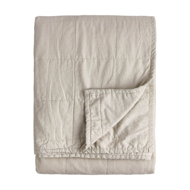 Hebden Percale Cotton Bedspread in stone, folded to show quilted grid stitching and a soft, garment-washed cotton texture on a plain white background.