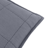 Close-up of the Hebden Percale Cotton Cushion in denim blue, showing square-grid quilted stitching and an Oxford border edge on a plain white background.