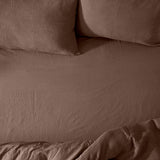Hebden Percale Cotton Fitted Sheet in cocoa brown on a bed, shown with matching waffle-texture pillowcases and duvet in the same tone.