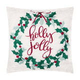 Square white bouclé cushion embroidered with a green holly wreath, red berries, a red bow, and "holly jolly" script, shown on a plain background.
