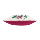 Side view of the Holly Wreath Bow Velvet Cushion showing cream bouclé fabric with embroidered holly and red bow trim above a magenta velvet base, on a white background.