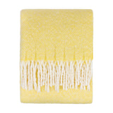 Isla Plain Polyester Throw in butter yellow, folded with a woven flecked texture and long cream tasselled fringe, shown on a plain white background.