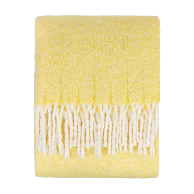 Isla Plain Polyester Throw in butter yellow, folded with a woven flecked texture and long cream tasselled fringe, shown on a plain white background.