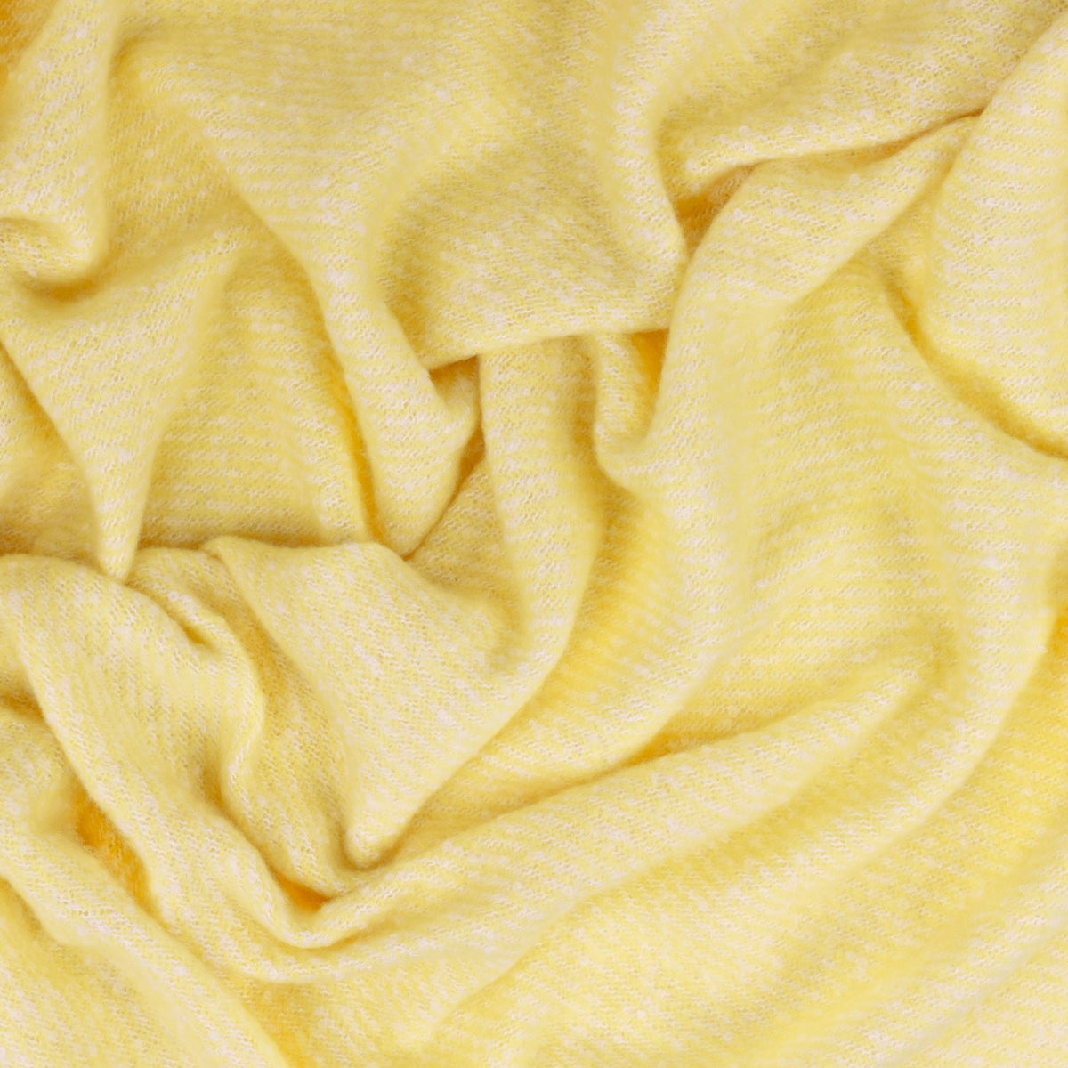 Isla Plain Polyester Throw in butter yellow, softly draped to show its woven texture with fine cream flecks creating a subtle two-tone effect.