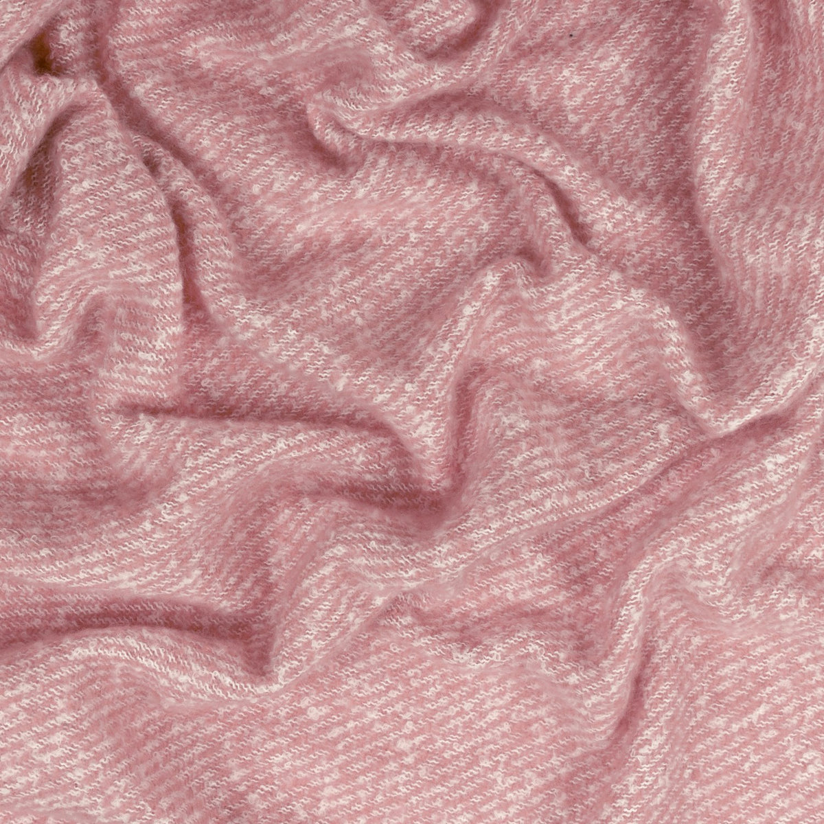 Isla Plain Polyester Throw in Heather, a rumpled woven blanket with a dusky pink, twill-textured surface flecked with paler tones for a heathered finish.