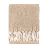 Isla Plain Polyester Throw in natural beige, folded with diagonal weave and cream flecks, edged with knotted white tassel fringe on a plain white background.