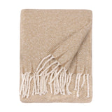 Isla Plain Polyester Throw in natural beige, folded with a diagonal woven texture and knotted white tassel fringe, shown on a plain white background.