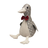 Jacquard duck-shaped door stop with grey and off-white floret-diamond pattern, cream suede-feel front, feet and beak, red bow tie, and black bead eyes.