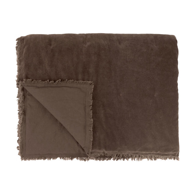 Jaye Velvet Cotton Bedspread in Bitter Chocolate, folded to show quilted brown velvet face and matte reverse with frayed fringe trim, on a white background.