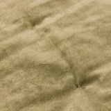 Close-up of the Jaye Velvet Cotton Bedspread in Moss, showing soft olive-green cotton velvet pile with visible fold lines and tufted stitch detailing.