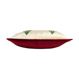 Side view of the Jolly Santa velvet cushion showing a plain red velvet back and cream printed front with green tree motifs, on a white background.