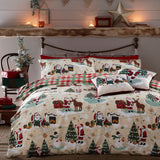 Jolly Santa Printed Gingham Duvet Cover Set in cream, red and green polycotton, styled on a bed in a rustic bedroom with festive Santa, reindeer and snowman print, plus red-green gingham pillowcases.