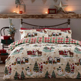 Jolly Santa Printed Gingham Duvet Cover Set on a bed, with cream fabric featuring Santa, reindeer, snowmen and trees, paired with red-green check reverse and pillowcases.
