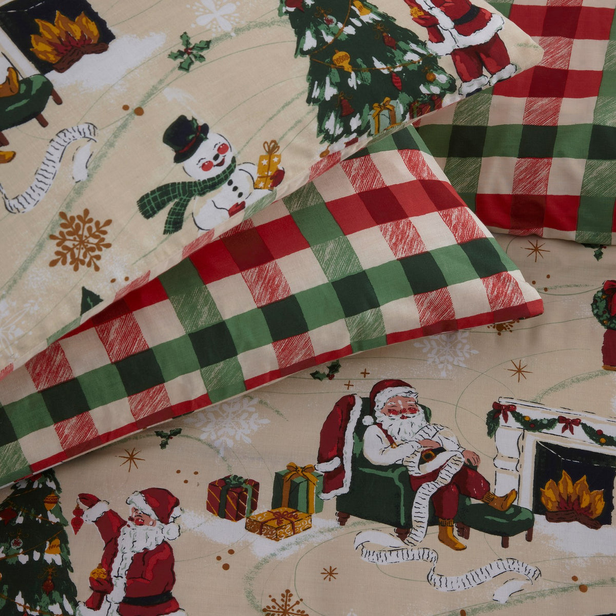 Jolly Santa Printed Gingham Duvet Cover Set in cream polycotton, with festive Santa, snowman and tree scenes paired with red and green check pillowcases.