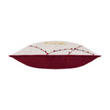 Side view of the Joy To All rectangular velvet cushion, showing cream front with embroidered "Mom" text and string-light motif, deep berry red back and piping, on a plain white background.