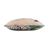 Side view of the Jungle Reversible Polyester Cushion showing both faces, blush pink jungle scene with birds on one side and green palm leaf print on the other, plain white background.