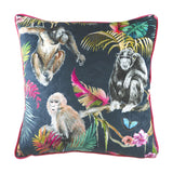 Jungle Animal Velvet Cushion in blue, featuring hand-painted primates and tropical foliage on a dark ground with pink piping, shown on a white background.