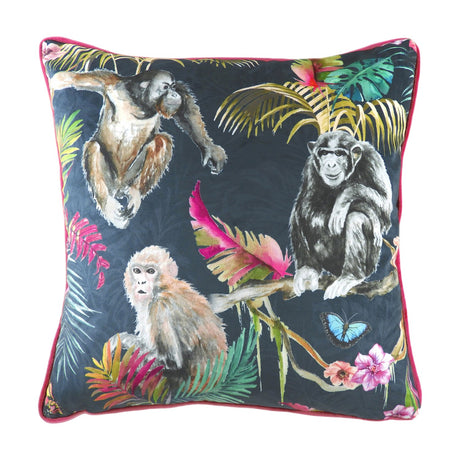 Jungle Animal Velvet Cushion in blue, featuring hand-painted primates and tropical foliage on a dark ground with pink piping, shown on a white background.