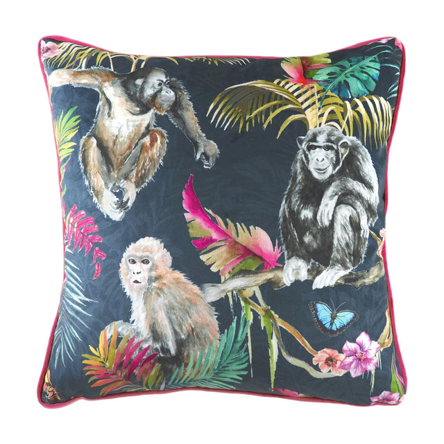 Jungle Animal Velvet Cushion in blue, featuring hand-painted primates and tropical foliage on a dark ground with pink piping, shown on a white background.