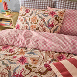 Juno Reversible Check Duvet Cover Set in multicolour on a bedroom bed, showing a pink and cream floral check side paired with checked and gingham pillows.