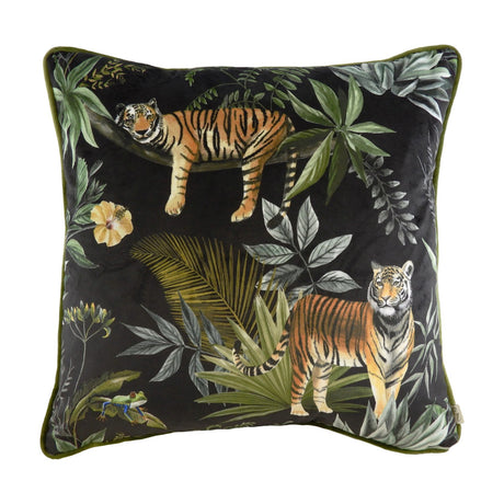 Square black velvet cushion with printed jungle scene featuring two tigers, tropical leaves, a hibiscus flower and a tree frog, finished with green piped edging.