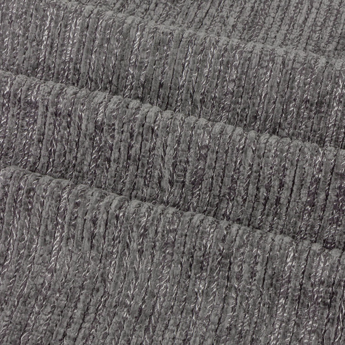 Close-up of Jupiter chenille jacquard fabric in graphite, showing ribbed horizontal texture with fine pearlescent threads woven through the fully lined eyelet curtain panel.