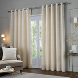Jupiter Chenille Fully Lined Eyelet Curtains in ivory/gold with subtle horizontal weave, shown on a chrome pole beside a French door in a living room setting.