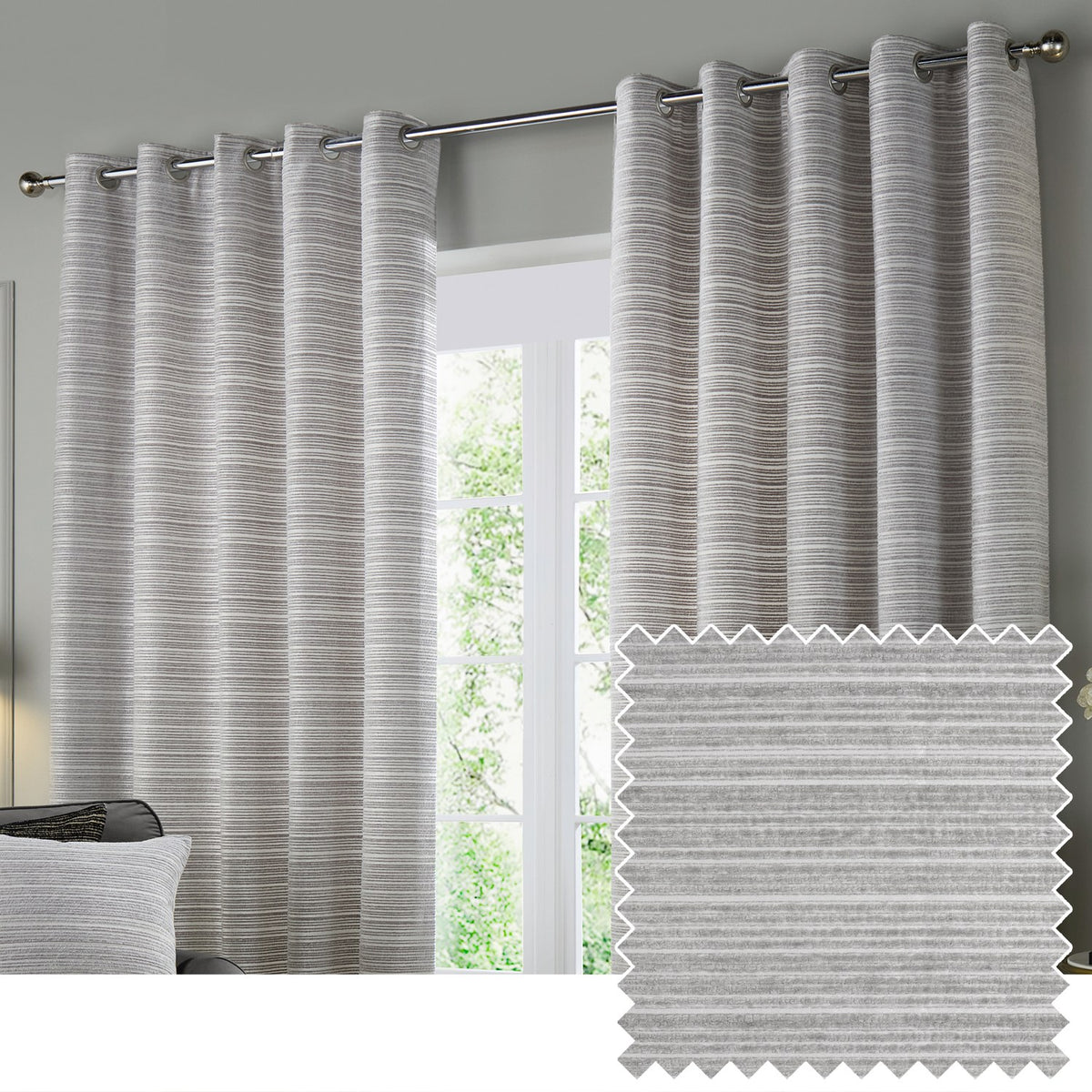Jupiter Chenille Fully Lined Eyelet Curtains in silver, hung on a chrome rod beside a window, showing subtle horizontal texture, with a fabric swatch inset.