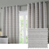 Jupiter Chenille Fully Lined Eyelet Curtains in silver, hung on a chrome rod beside a window, showing subtle horizontal texture, with a fabric swatch inset.