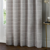 Jupiter Chenille Fully Lined Eyelet Curtains in silver, hung in soft folds beside a window, showing fine horizontal woven texture and eyelet header detail.