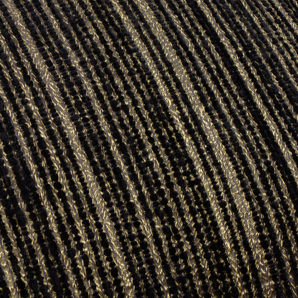 Close-up of the Jupiter Jacquard Chenille Cushion in black and gold, showing fine diagonal ridged stripes in a textured chenille weave with pearlescent gold detailing.
