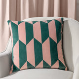 Kalho Jacquard Velvet Cushion in pink and green, geometric chevron pattern, styled on a cream armchair against a pink curtain background.