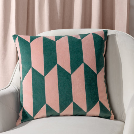 Kalho Jacquard Velvet Cushion in pink and green, geometric chevron pattern, styled on a cream armchair against a pink curtain background.