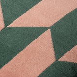 Close-up of the Kalho Jacquard Velvet Cushion in pink and green, showing the woven geometric triangle pattern and textured velvet pile in detail.