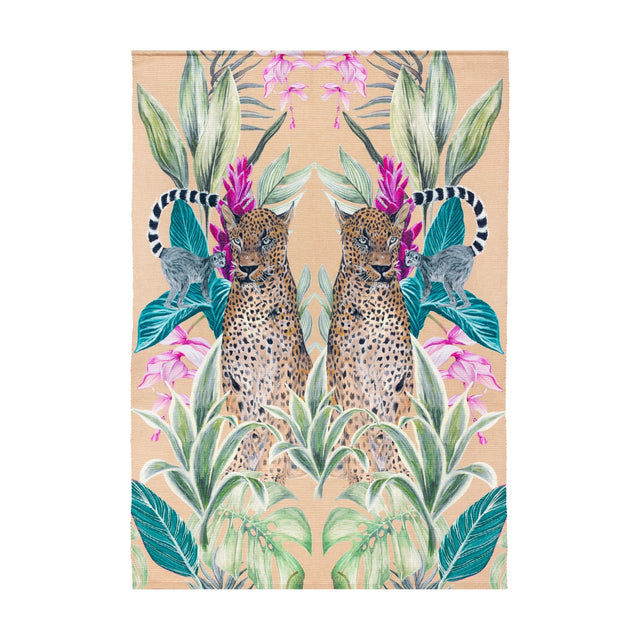 Kali Leopards polyester rug in gold, featuring a mirrored print of two leopards, ringtailed lemurs, green foliage and pink flowers, shown on a plain white background.